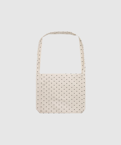 Opdag Dotted Cross Body Bag, en praktisk og moderne crossover-taske i slidstærk GOTS-certificeret økologisk bomuldscanvas. Den brede rem og signaturprikkerne giver et unikt og stilfuldt look, mens den rummelige størrelse gør den perfekt til hverdagens behov. En funktionel og bæredygtig taske til dig, der ønsker både stil og komfort.
