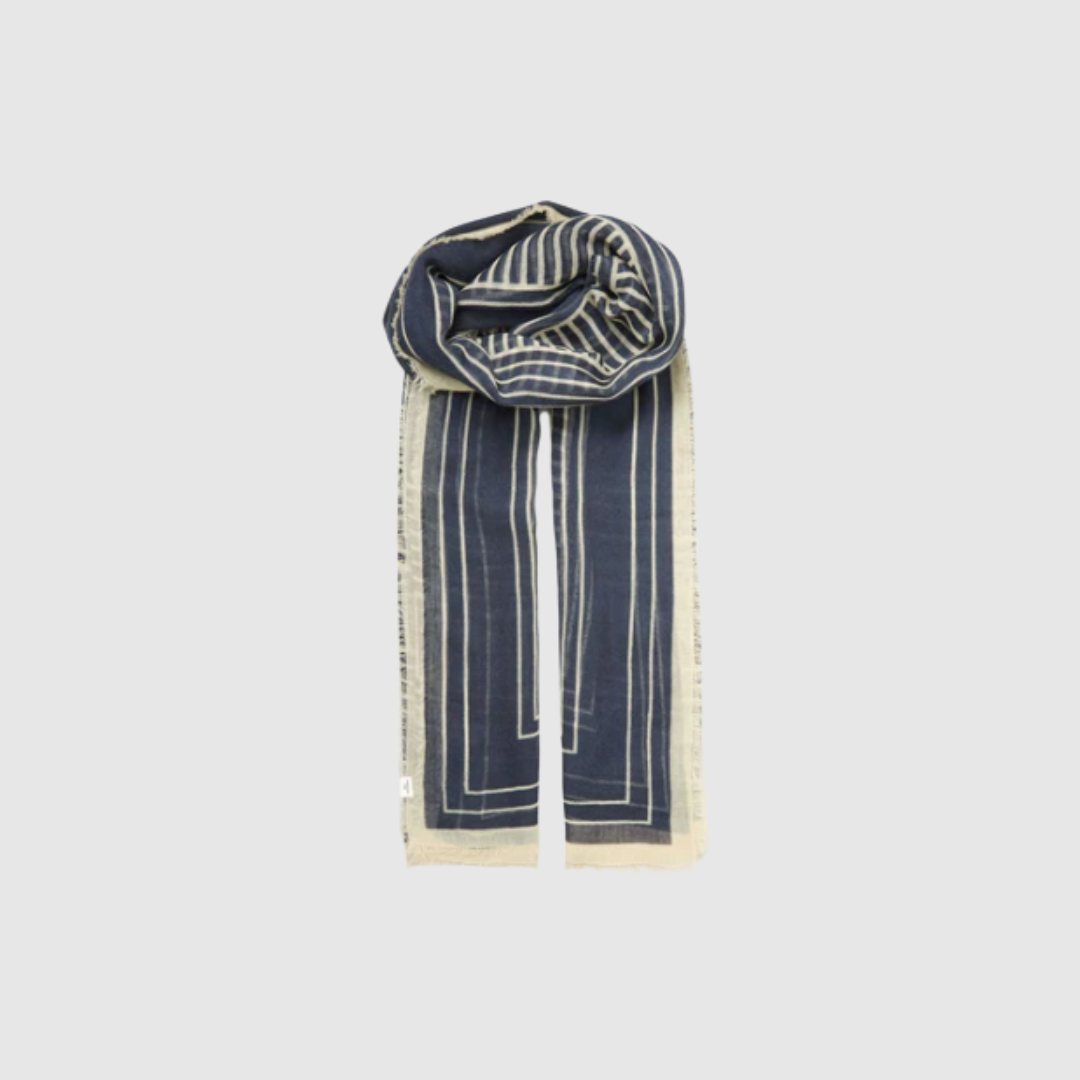Opdag Anniea Woo Scarf – Navy Blue, et stort og luksuriøst tørklæde fra Becksöndergaard i 100% blød uld. Det grafiske design og den dybe marineblå farve gør tørklædet både moderne og tidløst. Med sin generøse størrelse på 100 × 200 cm er det perfekt til både hverdagsbrug og elegante stylinger, hvor varme og stil går hånd i hånd.