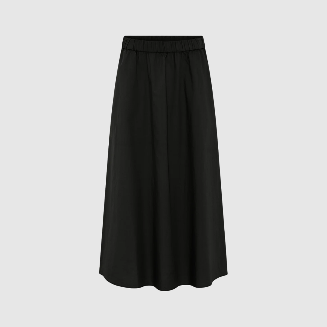 Melbourne Ankel Nederdel – Black fra FRAU er en lang, stilren nederdel i 100% økologisk bomuld. Med elastik i taljen, sidelommer og ekstra vidde i bunden er den både praktisk, komfortabel og elegant. En perfekt basisstyle til både hverdag og pæne anledninger.