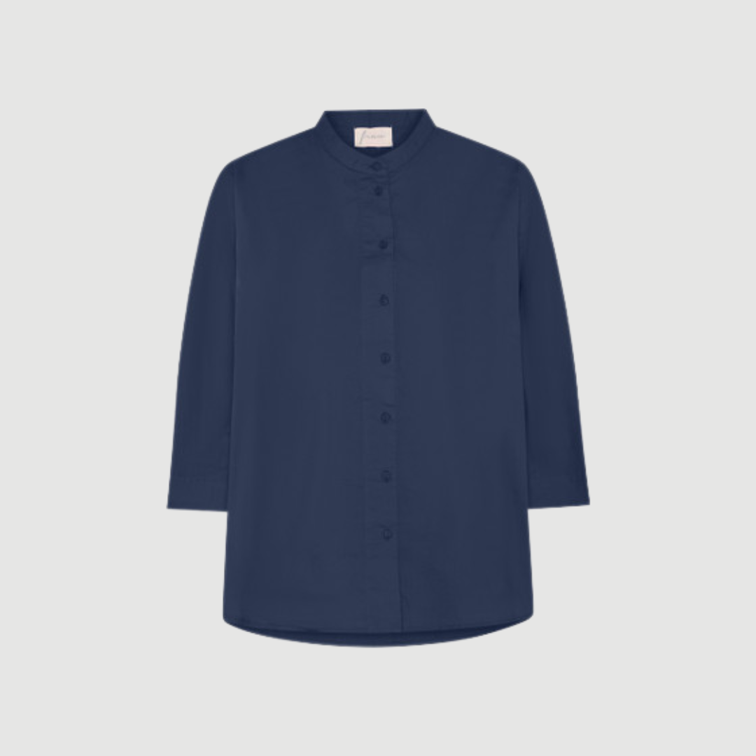 Seoul Short Shirt fra FRAU i farven Navy Blazer (India Ink) er en kort, oversized skjorte i 100 % økologisk bomuld. Skjorten har kinakrave, gennemknapning og et let, afslappet snit, der gør den perfekt til både hverdag og afslappede looks. Find FRAU Seoul Short Shirt hos Merci Give.