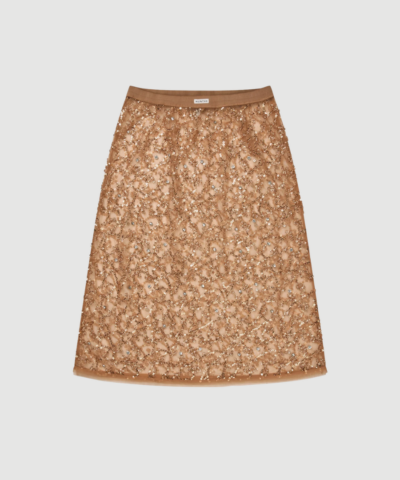 Ninia Skirt fra MUNTHE er en elegant nederdel i Old Brass med transparente pailletdetaljer og elastisk talje. En festlig og stilfuld nederdel, der nemt kan styles både til hverdag og aften. Find MUNTHE Ninia Skirt hos Merci Give.